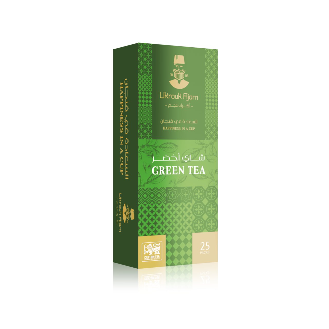 Vibrant green box of Ukrouk Ajam Green Tea containing 25 packs, adorned with traditional patterns and Arabic calligraphy, with the English slogan 'Happiness in a Cup'.
