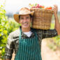 portrait-happy-farmer-carrying-basket-vegetables